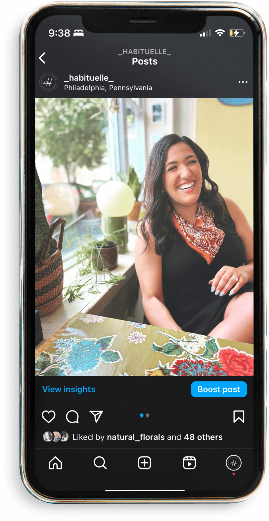 An image of a woman smiling on a phone screen.