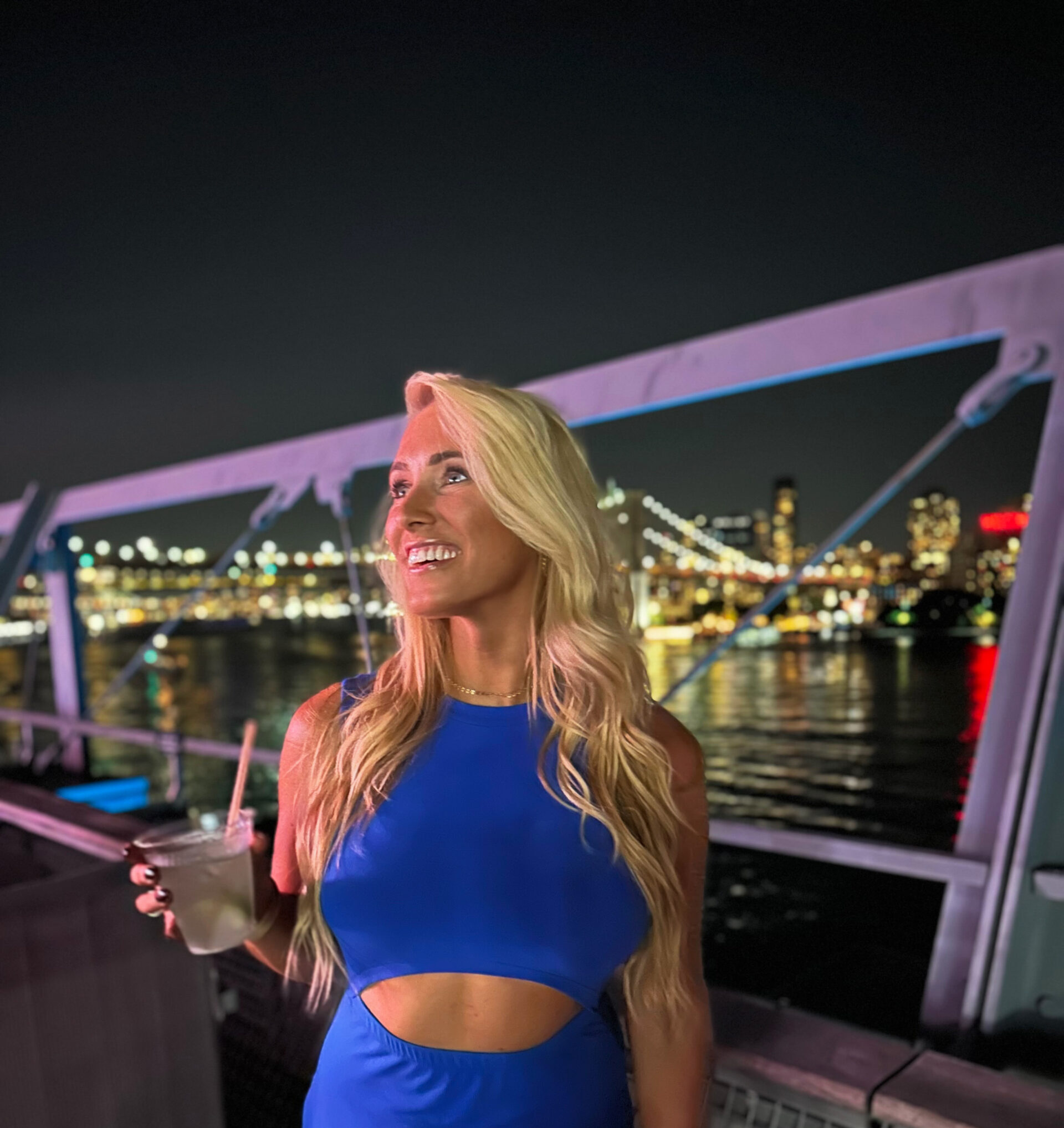 Woman smiling in a blue dress; Purpose-Driven Leadership Journey
